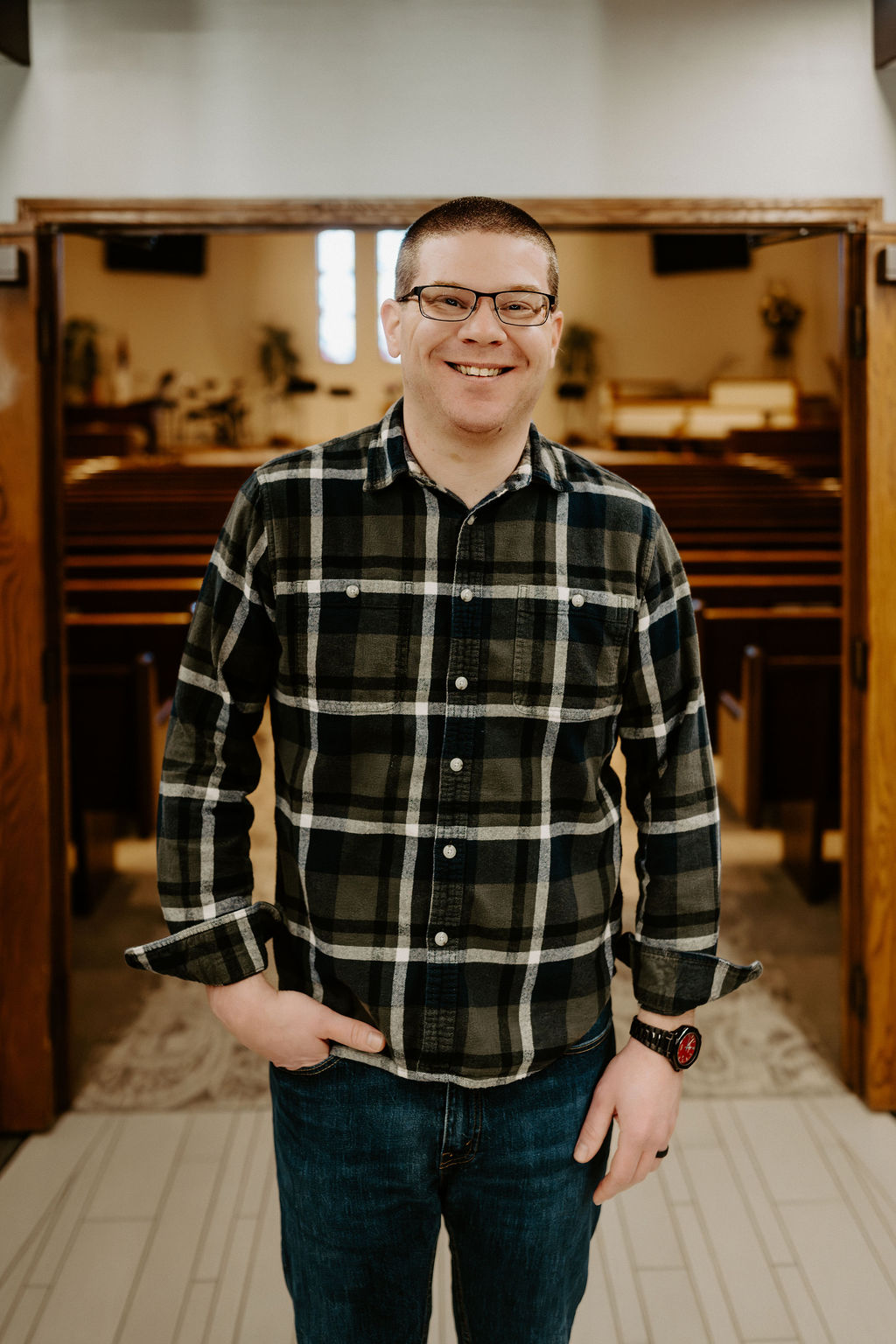 Craig Flack smiling in a plaid shirt
